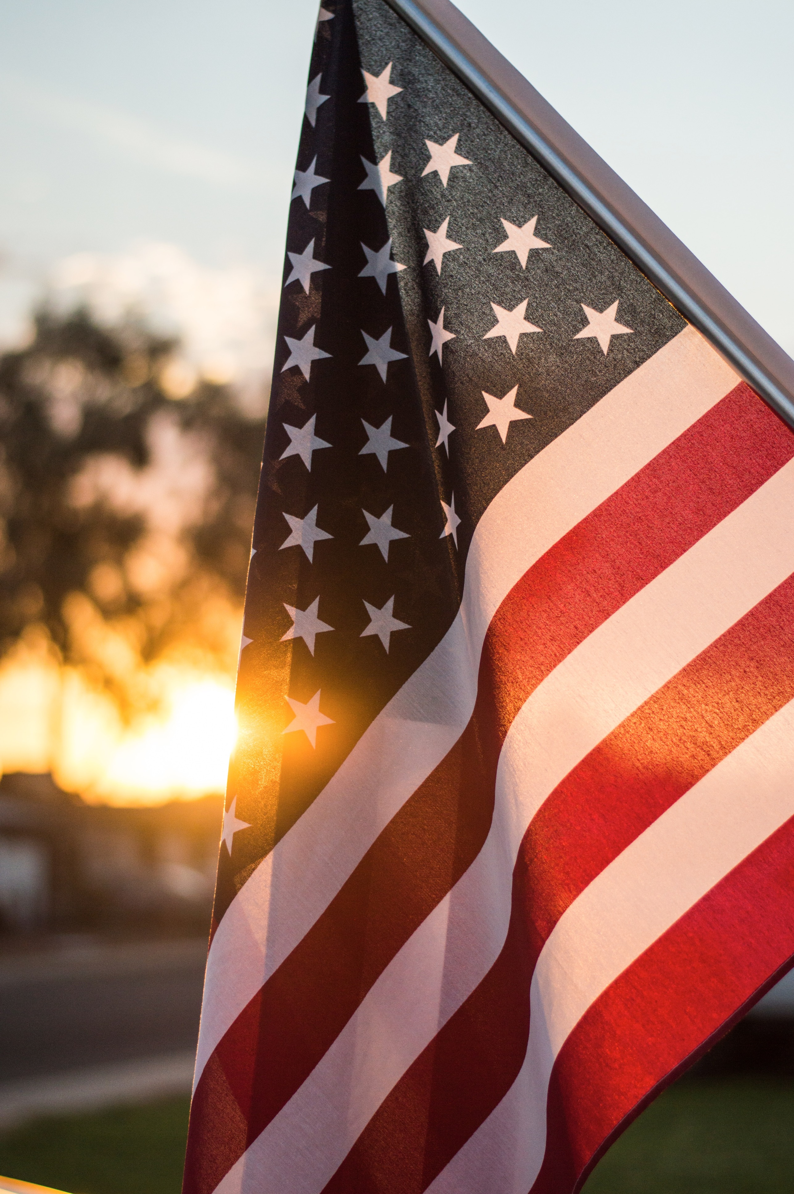 american flag with sun setting behind.jpg